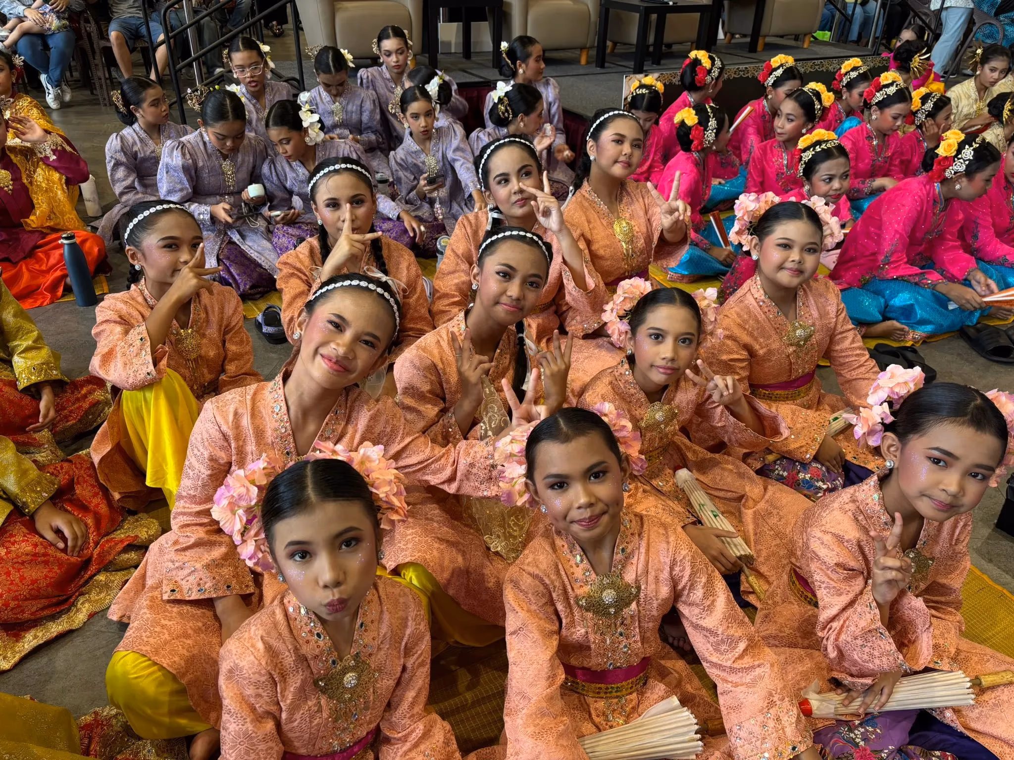 Dancers in their colourful costumes waiting for their turn to perform.